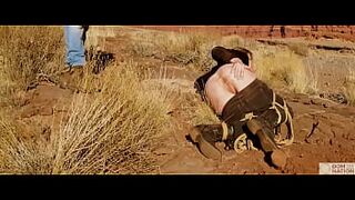 Giant-bum blonde gets her butthole whipped, then gets rough anal sex in dirt and piss -- a real BDSM session outdoors in the Western USA with Rebel Rhyder
